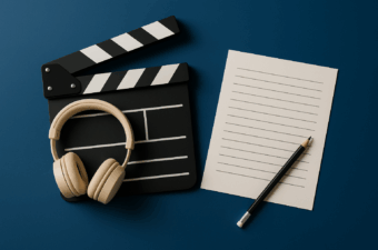 Clapperboard, headphones and notepad on a blue background.